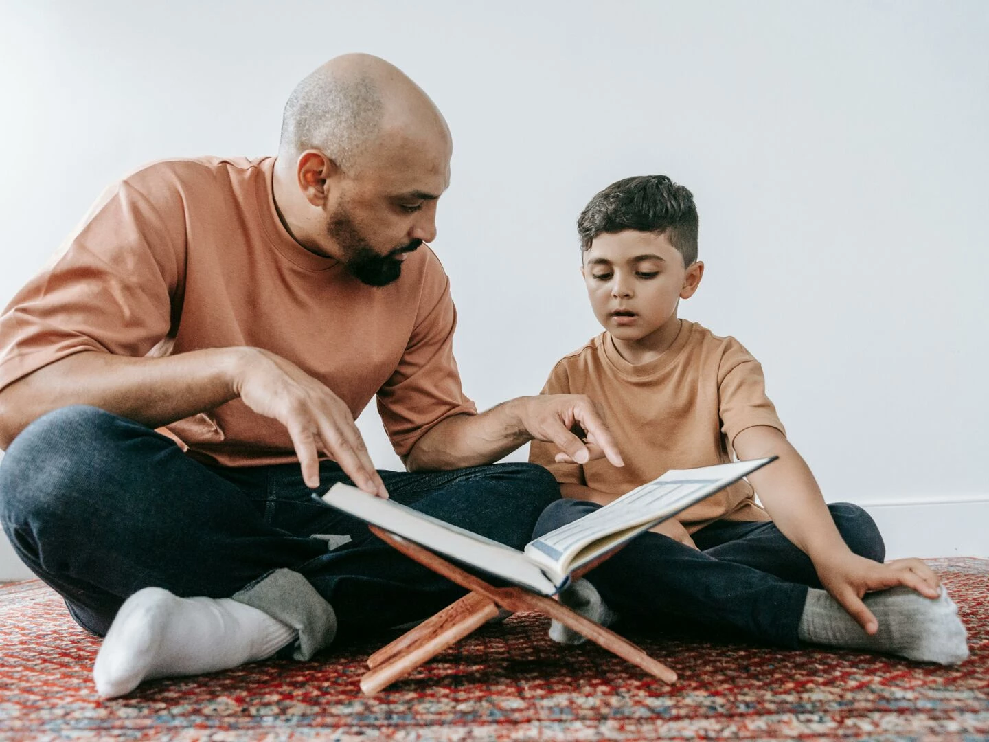 a father guides his son in reading a book promoting learning and bonding