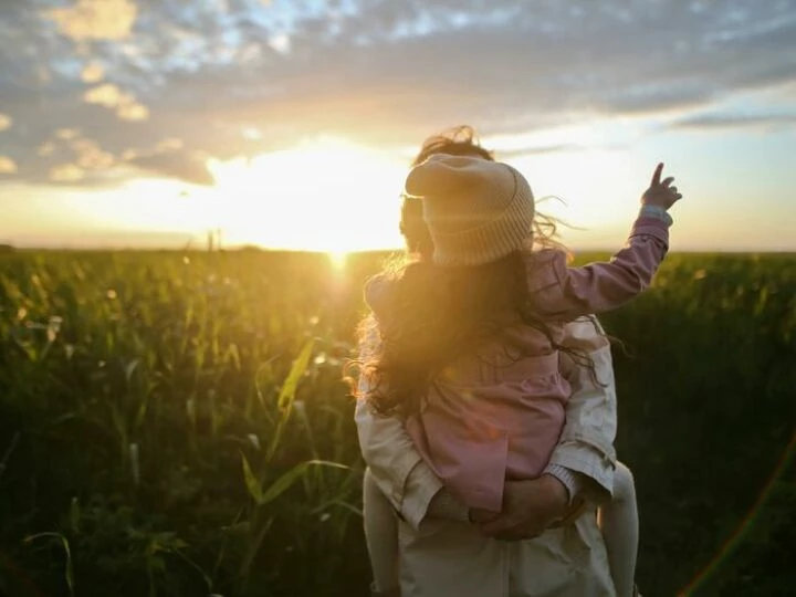 Mother and Daughter On Grass