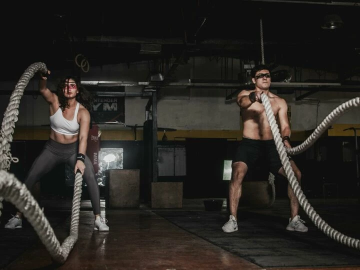 Man And Woman Holding Battle Ropes
