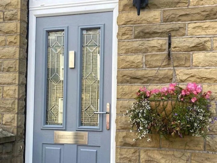 Pale grey front door with flowers