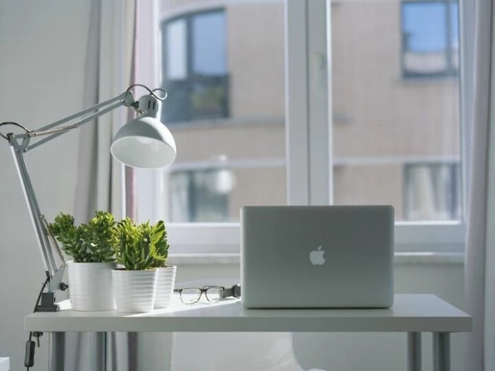Silver Macbook Air and Goose Neck Lamp