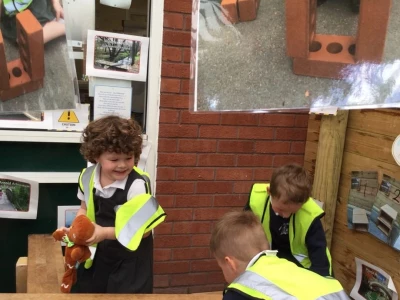 Three children from Amethyst Class playing outside