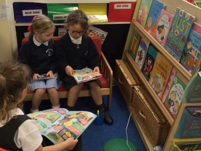 Three girls reading in Amethyst Class