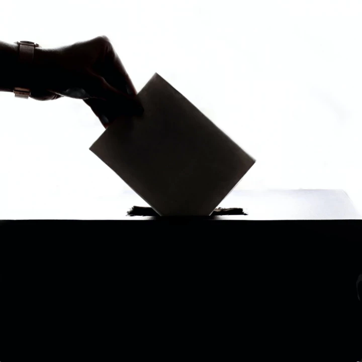 Person Dropping Paper On Box