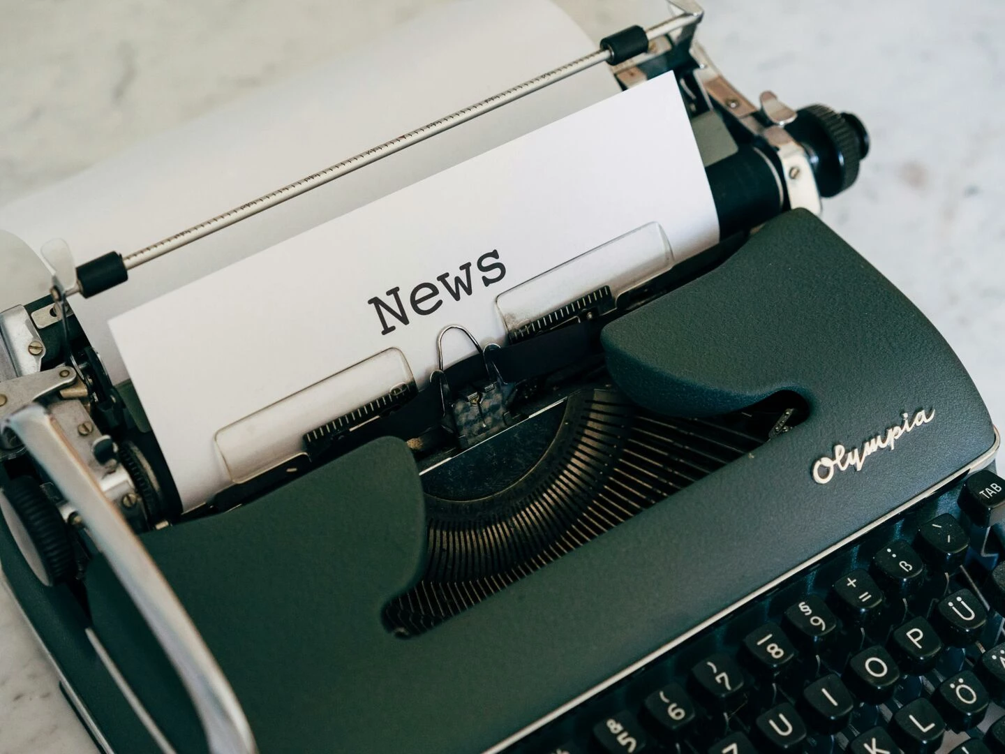 closeup of an antique typewriter with 39news39 on paper
