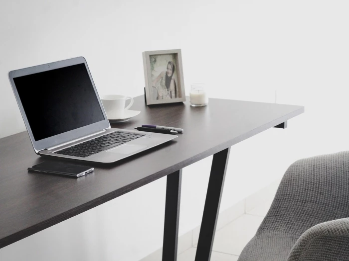 computer and coffee cups on an office desk