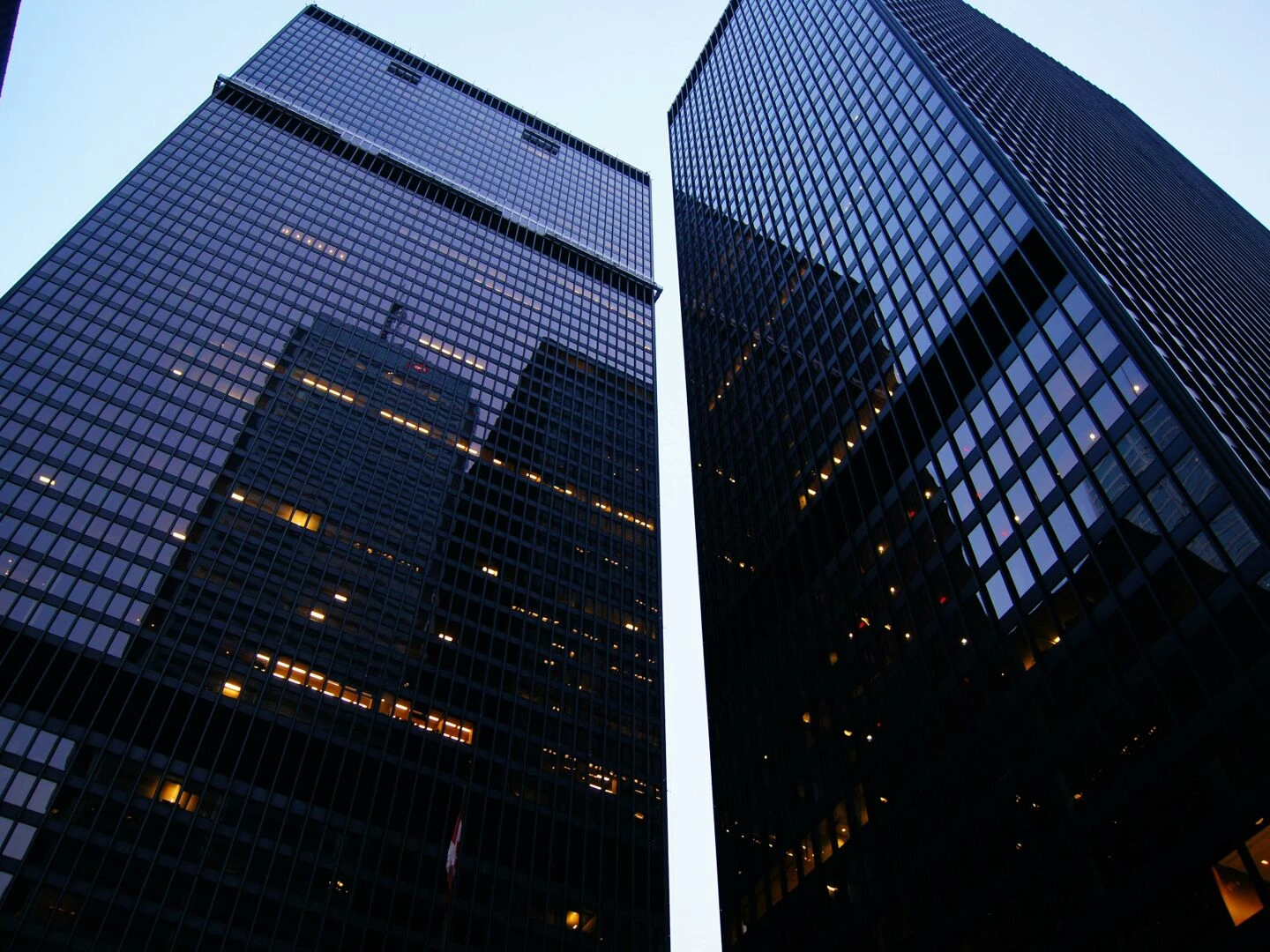 dramatic low angle view of toronto39s skyscrapers reflecting the evening sky