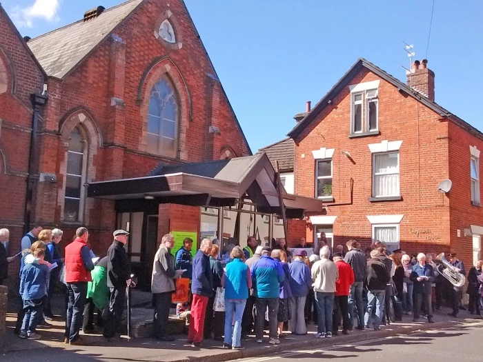 ecumencial walk of witness on good friday pauses outside wesley centre