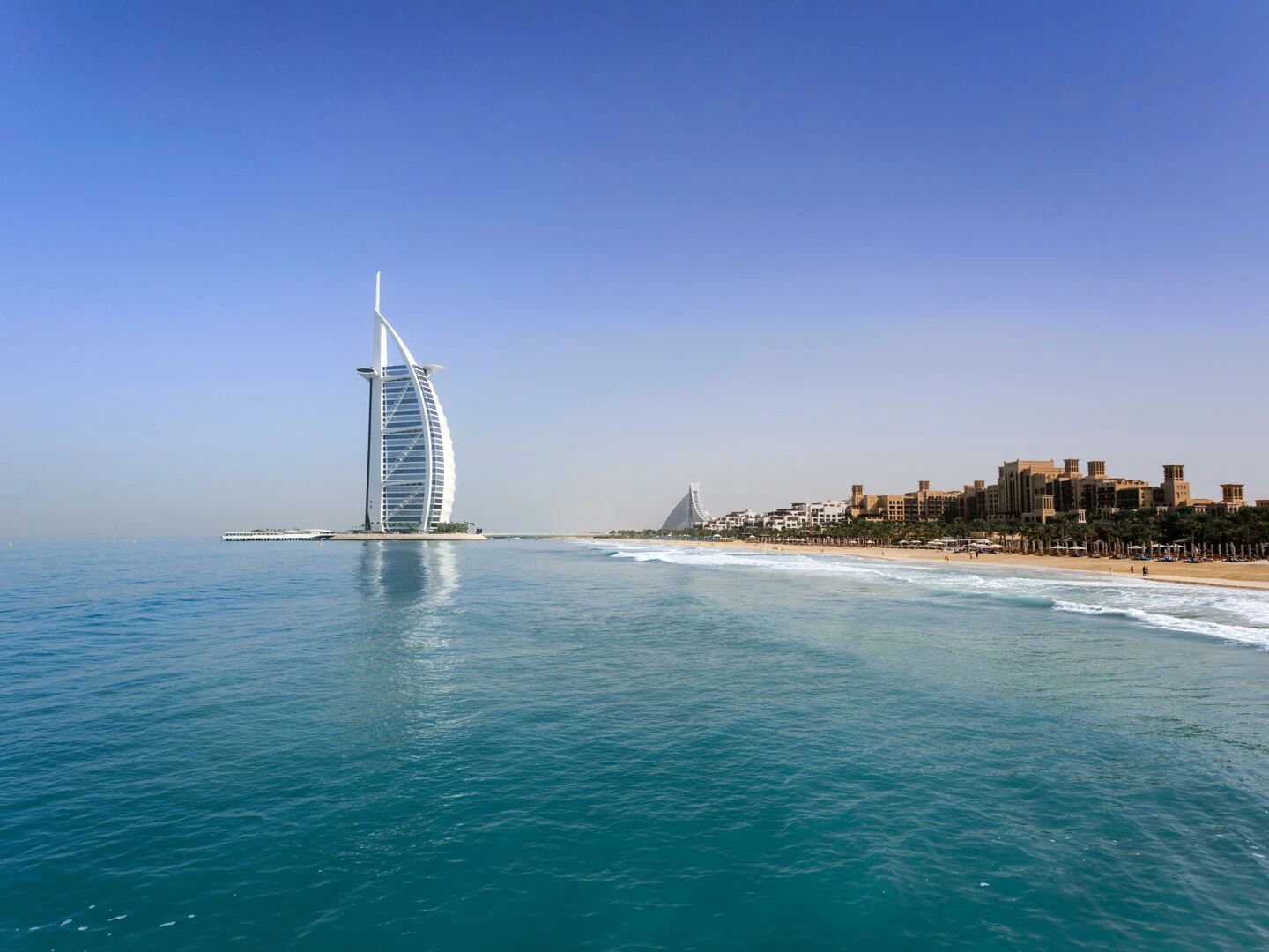 iconic burj al arab overlooking the pristine dubai beach perfect for travel and leisure