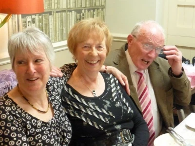 roland hall on knees with two ladies