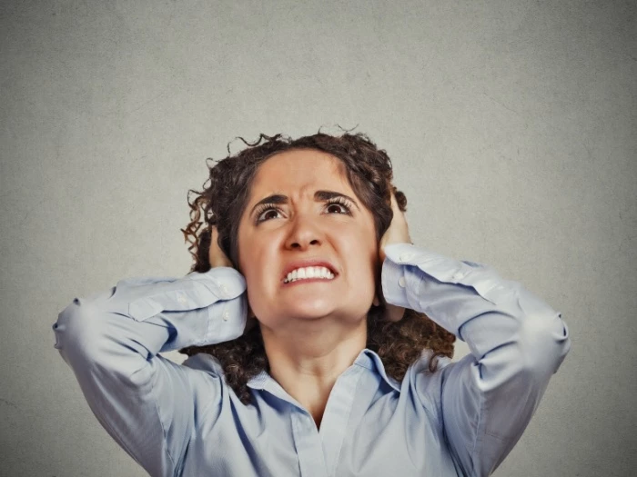 woman distressed at burglar alarm noise