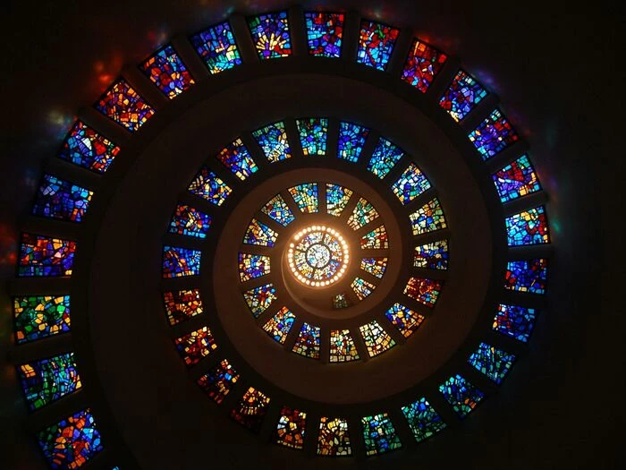 worms eye view of spiral stained glass decors through the roof